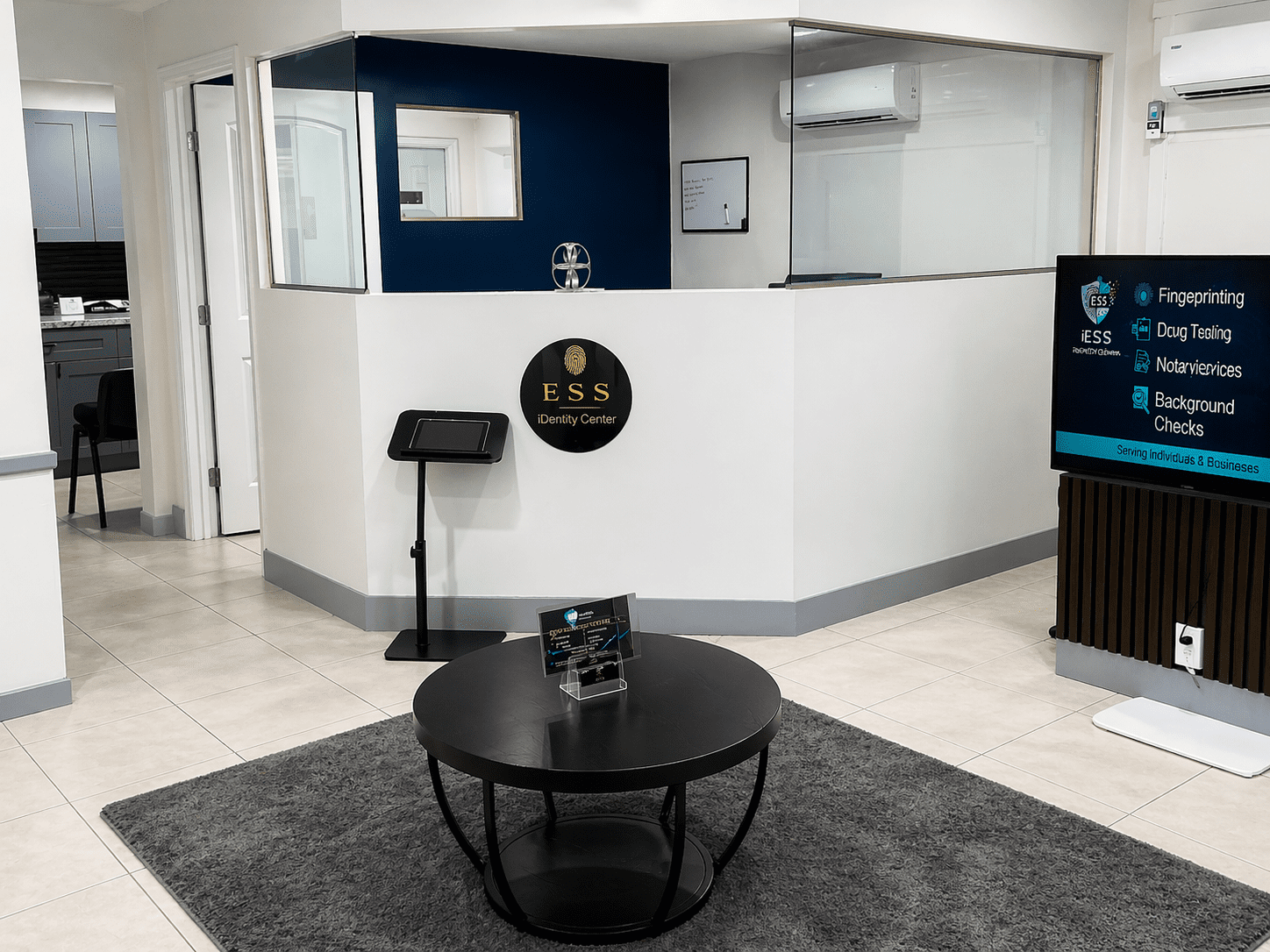 Modern waiting area with a reception desk and round coffee table.